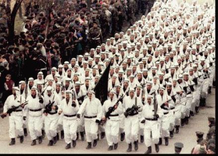 Bosnian Muslim Army troops of the Al-Qaeda linked El Mujahedeen Unit parade in downtown Zenica in central Bosnia in 1995, carrying the black flag of Islamic jihad.