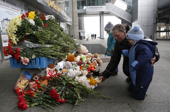 People lay flowers and toys at an entrance of Pulkovo airport.